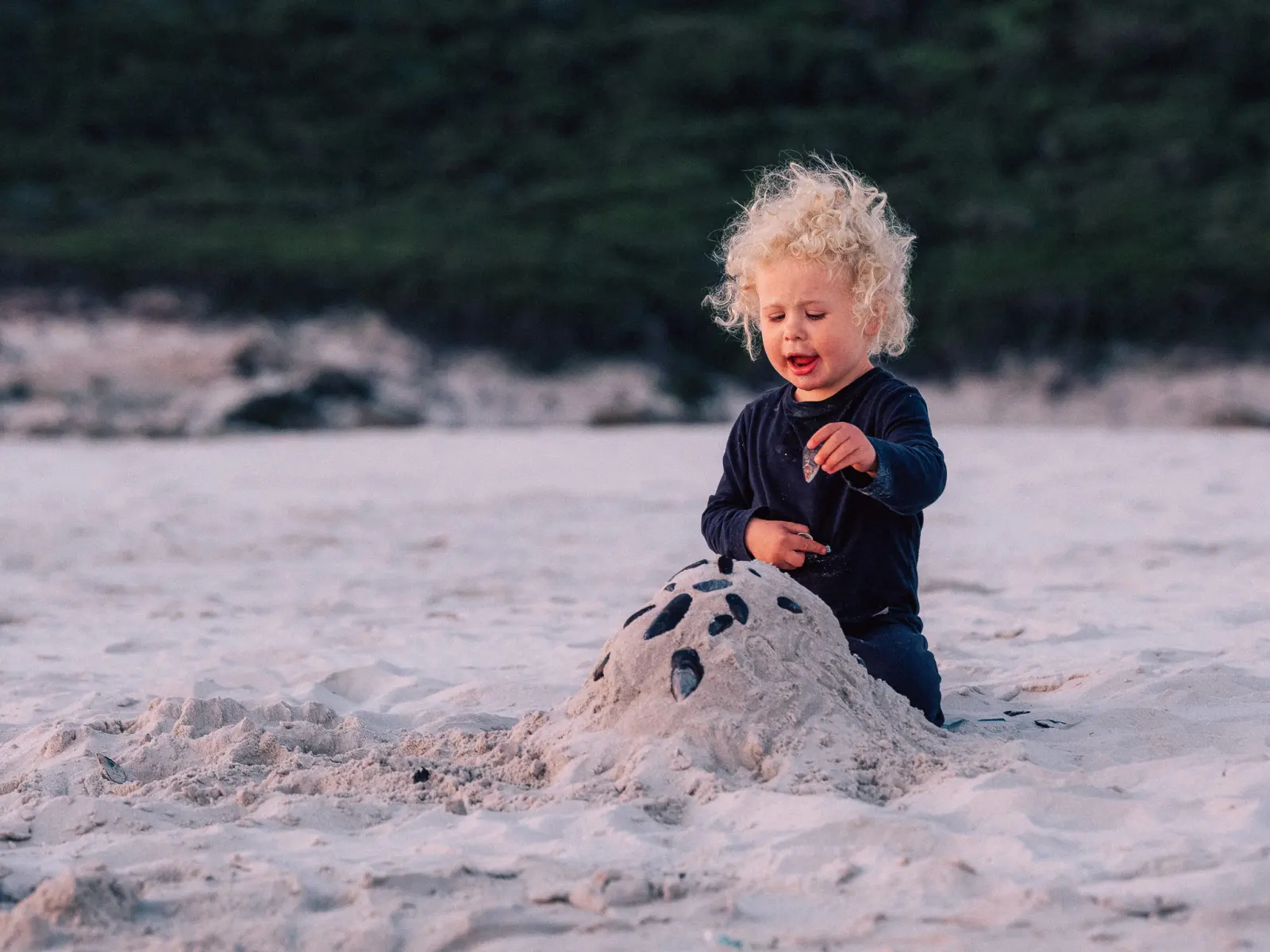 A child building in the sand